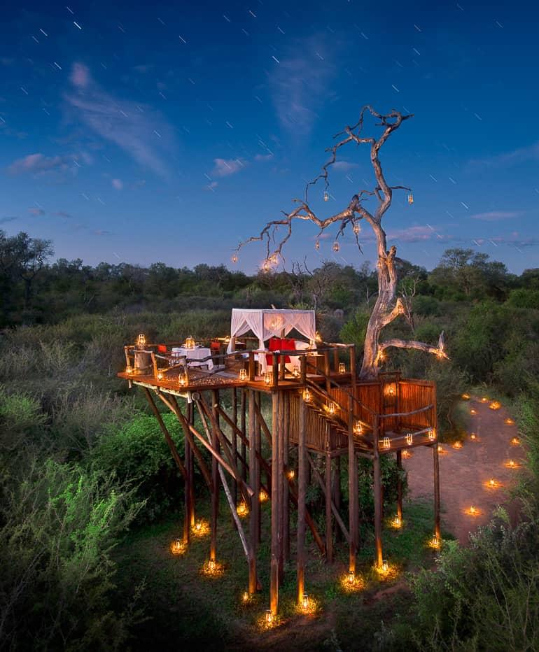 A dreamy four-poster bed in an open-air treehouse amidst African nature found at Chalkley Treehouse.