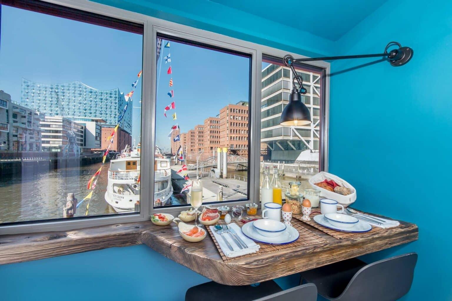 The view of the Elbphilharmonie from a set table in a floating hotel in Hamburg