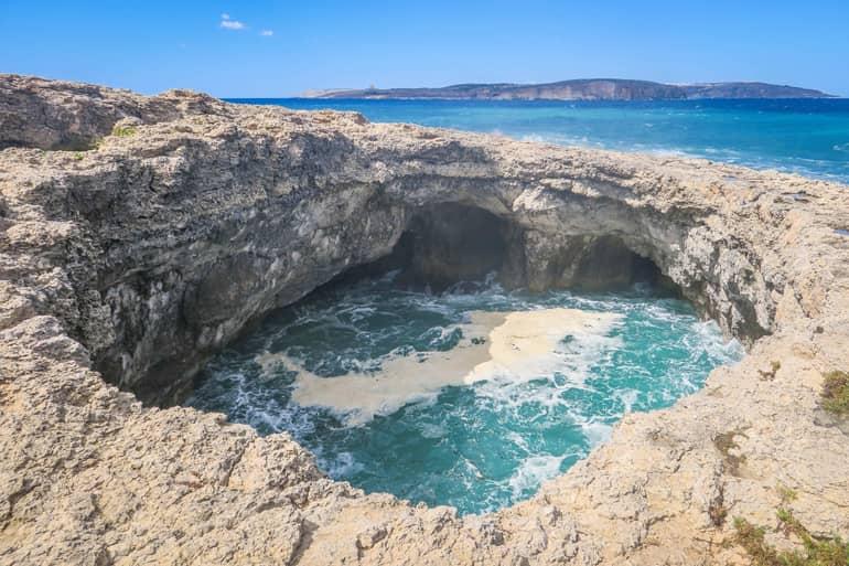 View from the cliff edge at the Devil's Hole - a natural hole filled with seawater in rhythm with the waves