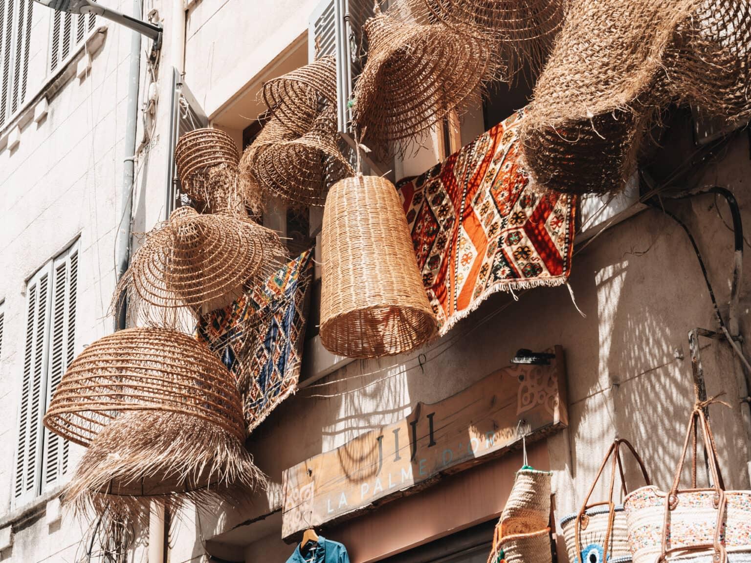 Colorful straw bags and lamps in a shop in Noailles in Marseille.