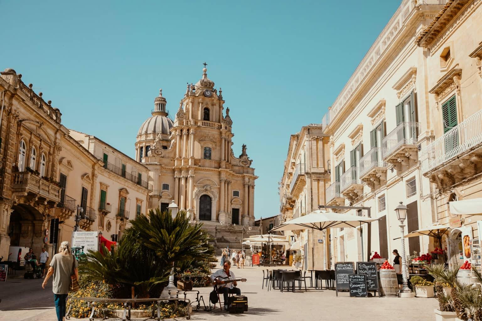 A bustling square in front of San Giorgio Cathedral in the town of Ragusa in Sicily.