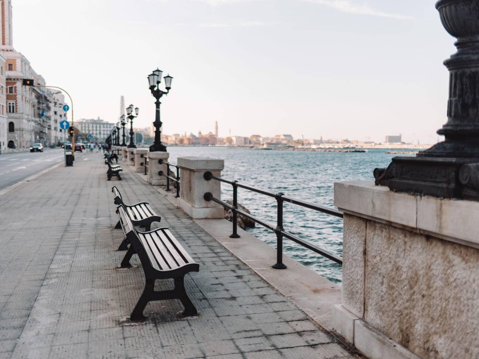 The promenade directly by the sea with the city in the background.
