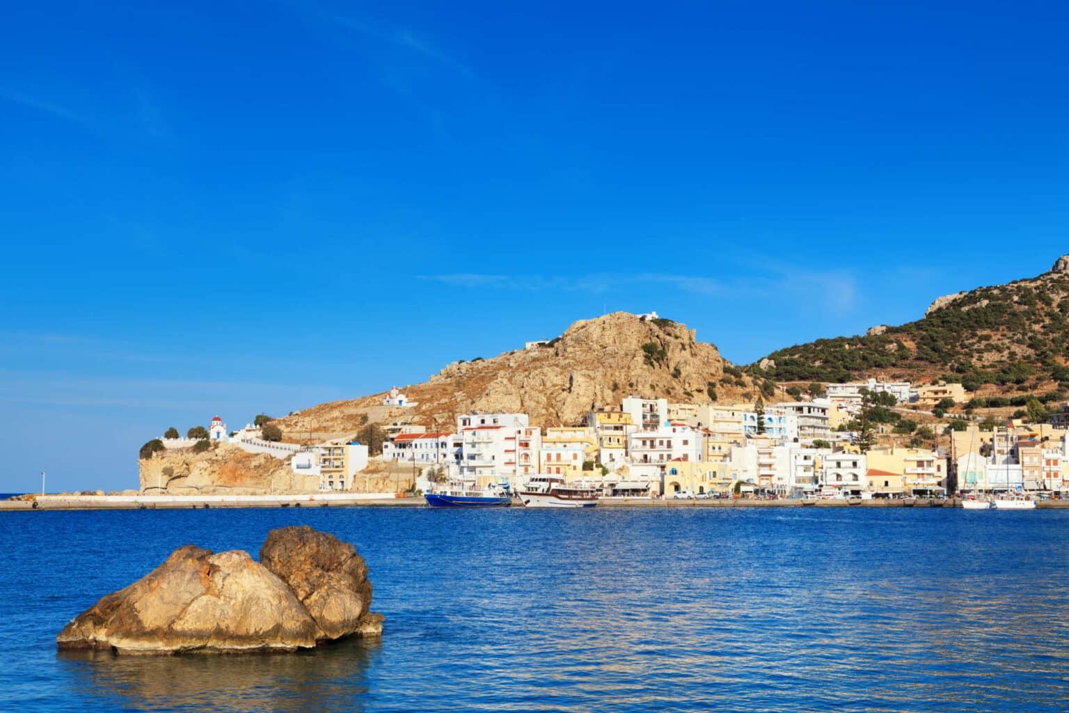 From Pigadia Beach, you enjoy a view over the sea to the rocky town of Pigadia on Karpathos.