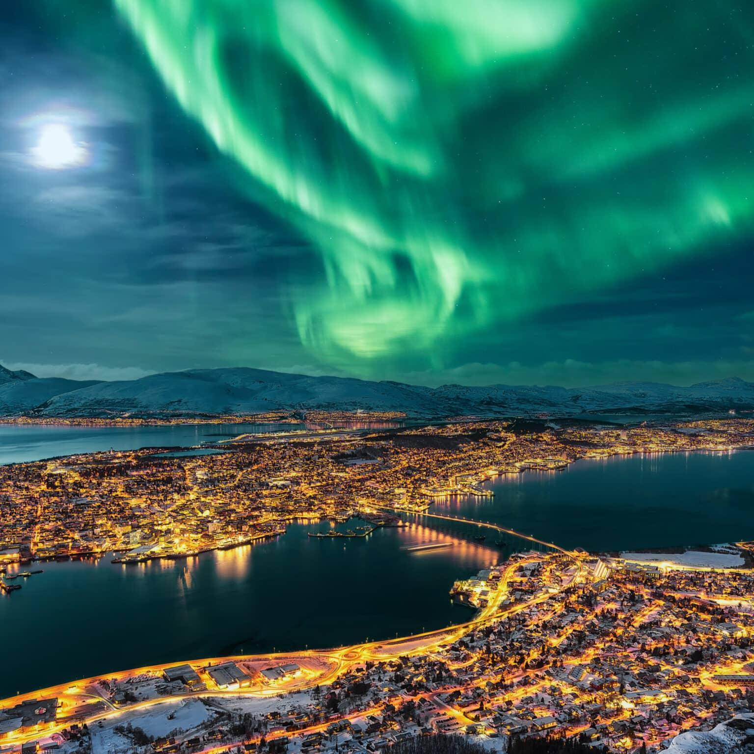 Northern lights over the skyline of Tromsø in Norway.
