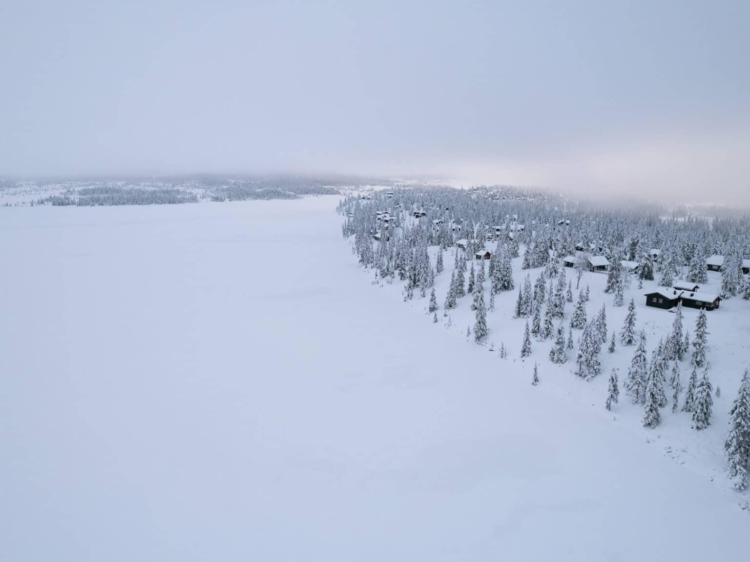 A frozen and snow-covered lake in the winter landscape in Sjusjøen.