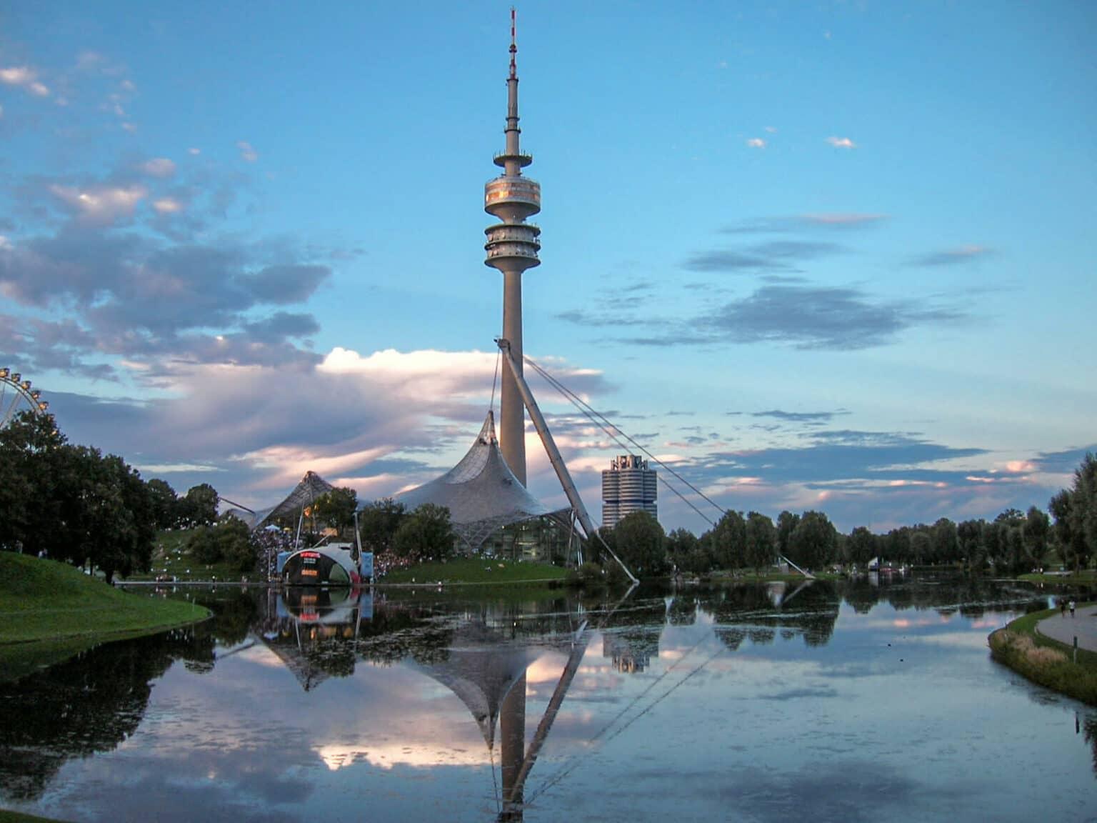 View of the Olympic Lake with the tower and the stadium in the Olympic Park in Munich.