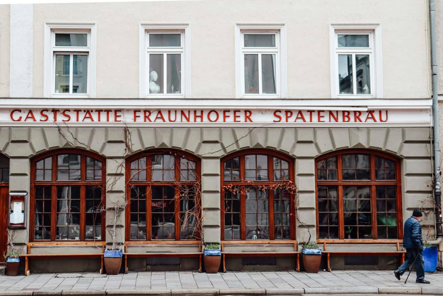 The Fraunhofer restaurant from the outside with red windows in Munich.