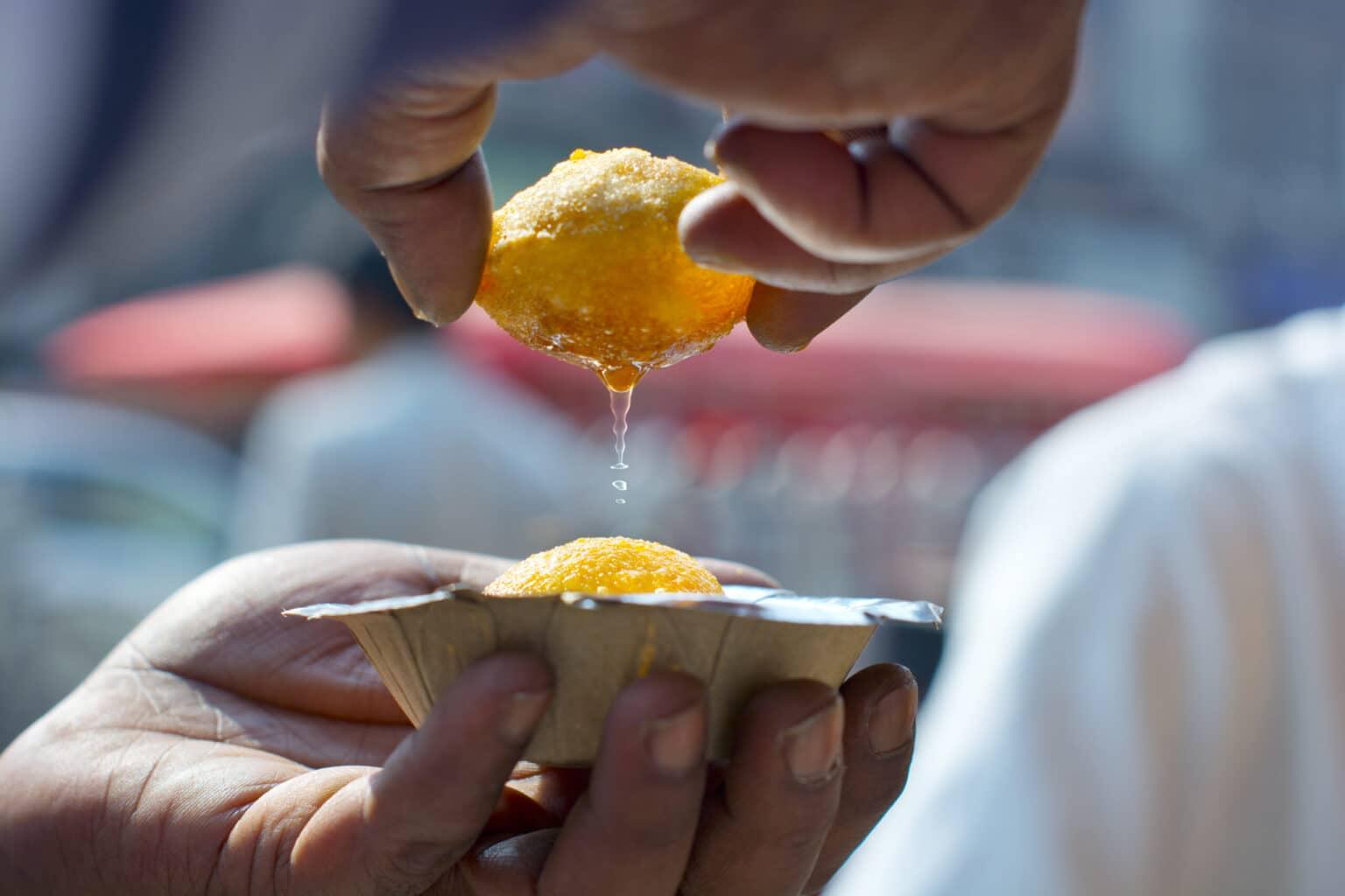 The fried dough balls Panipuri are best eaten with hands.