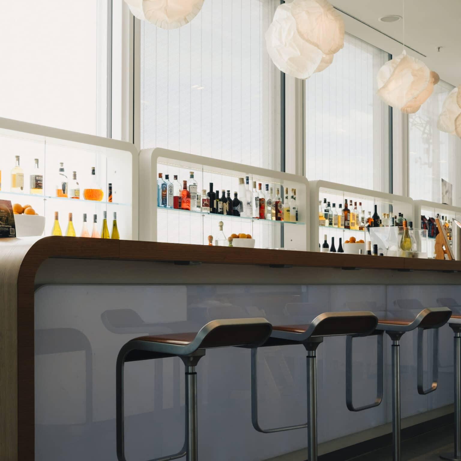 A bar with large windows and plenty of natural light.