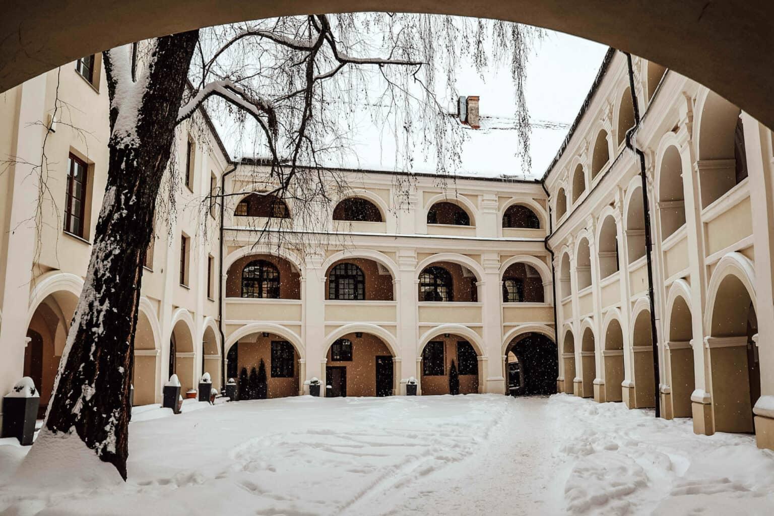 El patio nevado de la universidad en Vilnius con vista al edificio.