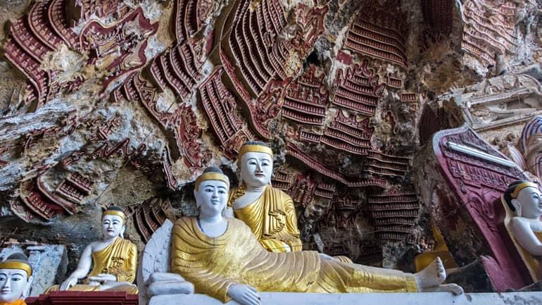 The cave temple in Myanmar is adorned with murals and Buddha statues; the Kawgun Cave is located in Hpa An.