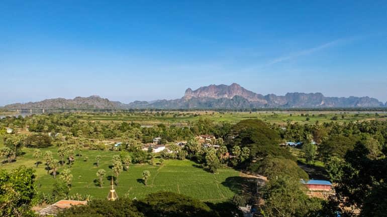 A view from above of Hpa An's green landscape, with mountains visible in the background.