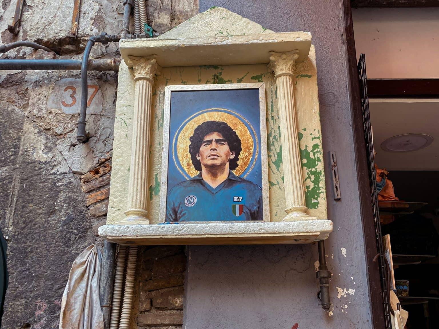 The almost sanctified image of Diego Maradona with a halo is kept in a small altar frame on a wall.