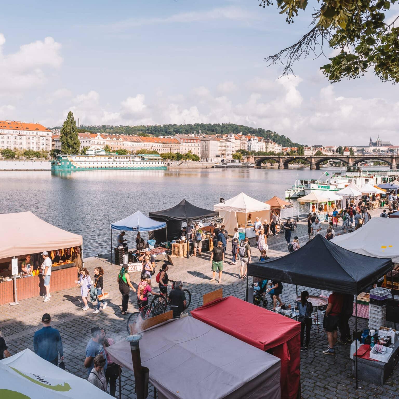 Many colorful stalls by the banks of the Vltava form the Saturday Farmers Market in Prague.
