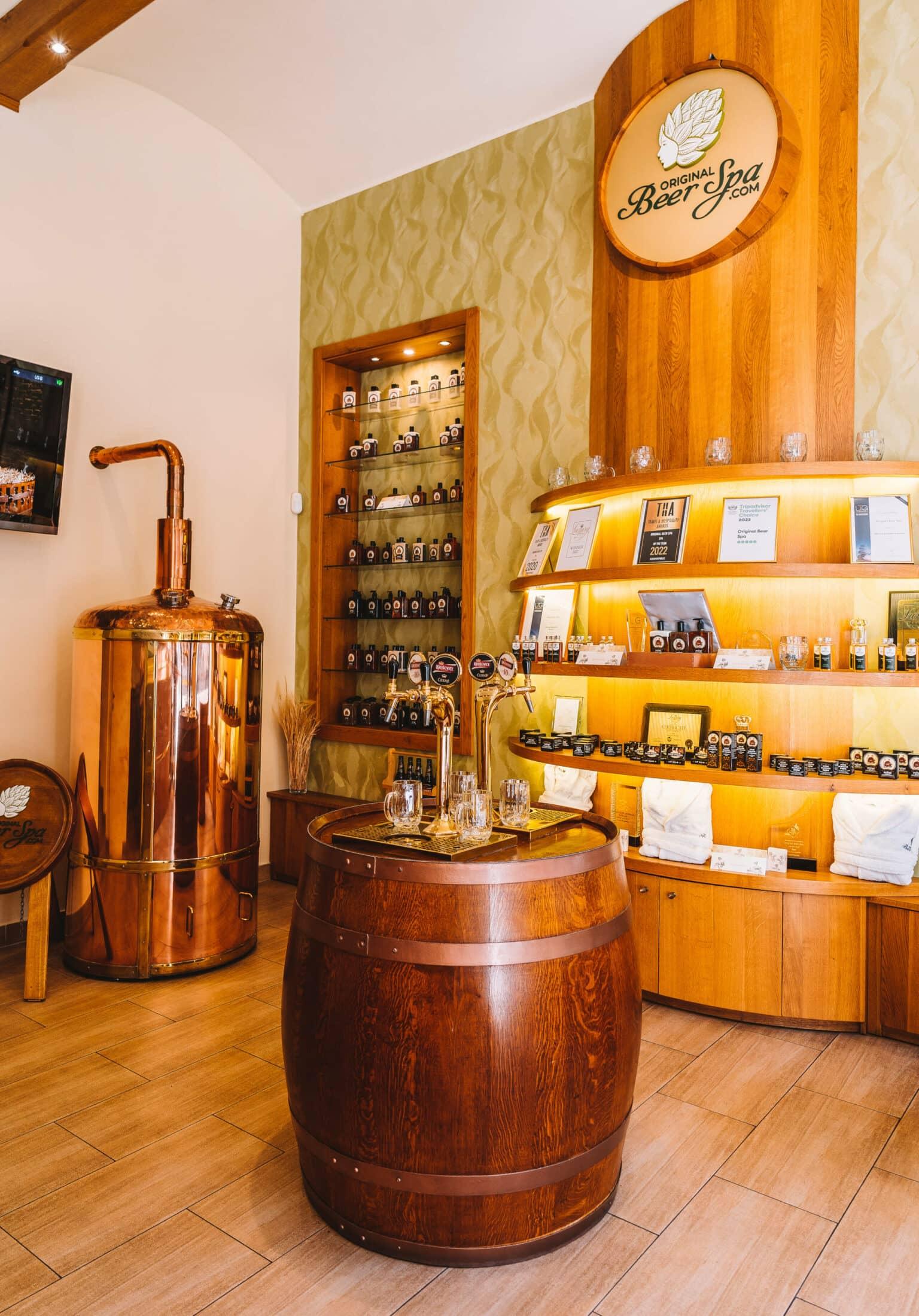 The interior of a beer spa in Prague with a wooden barrel in the center and many souvenirs.