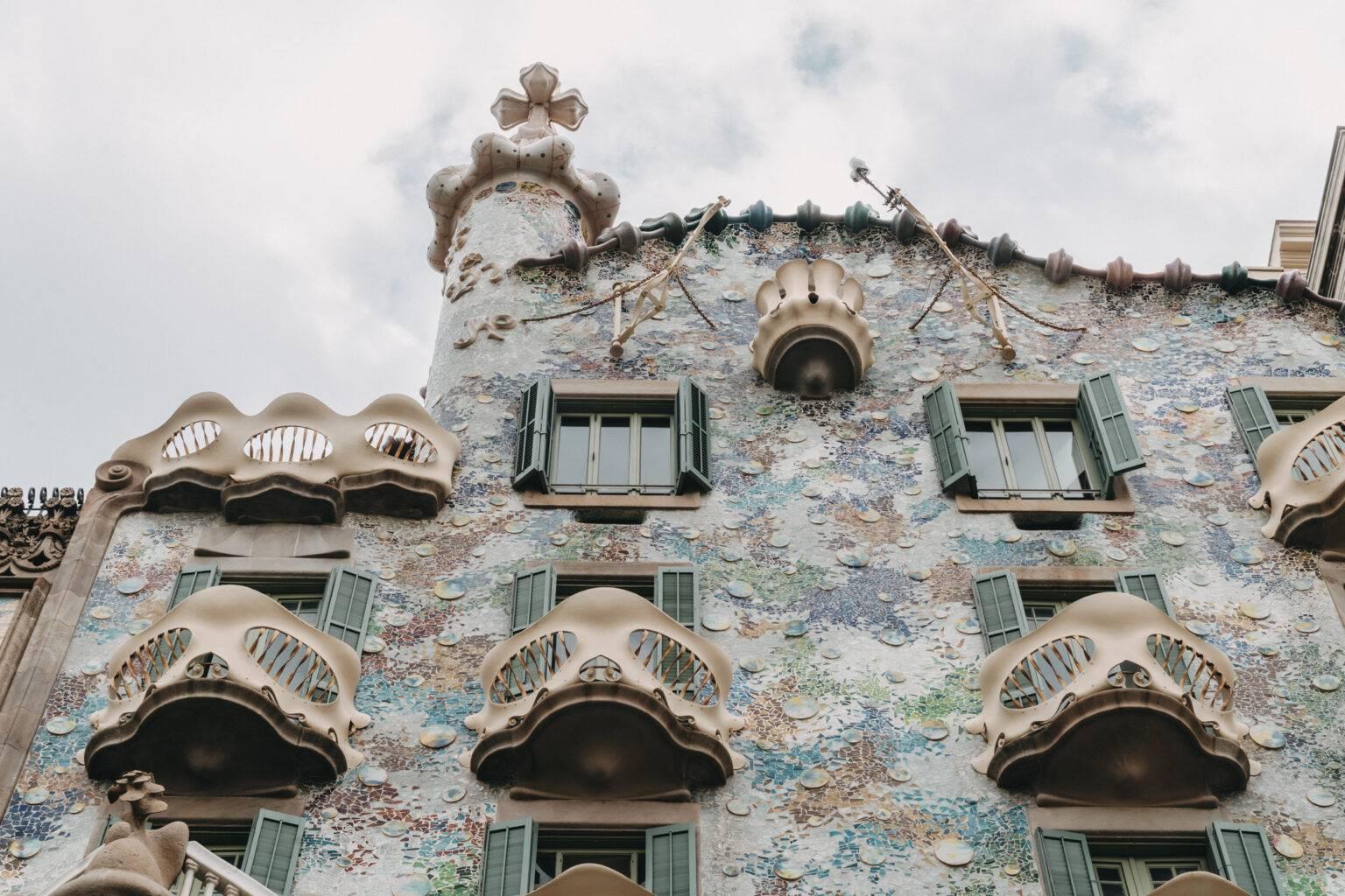 The facade of Casa Batlló with blue, green, and orange mosaics.