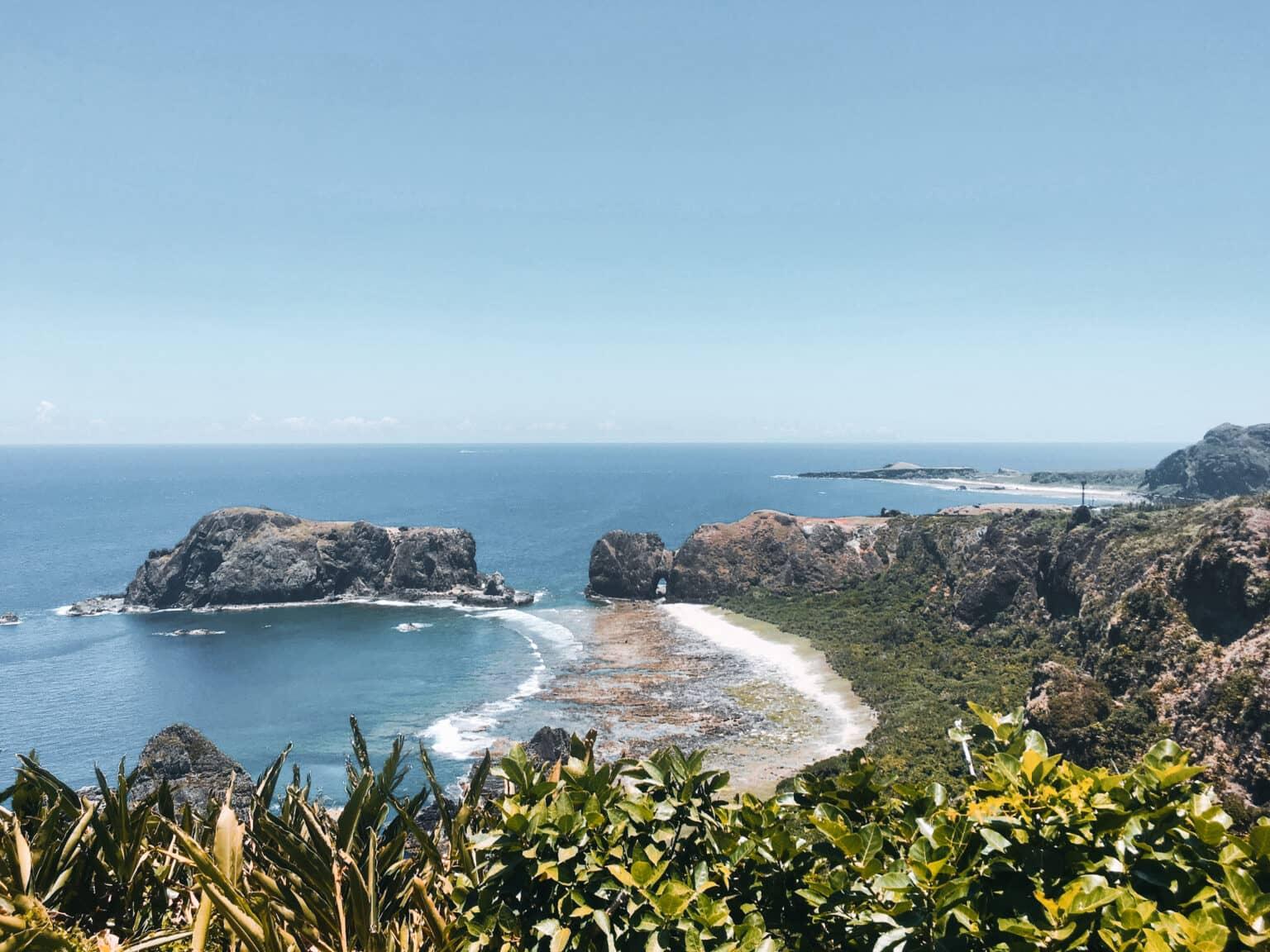 A rocky bay on Green Island in Taiwan with blue sea.