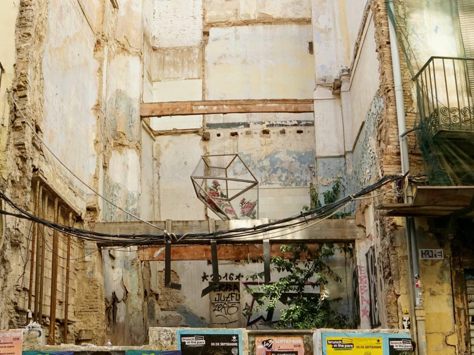 A hidden gem in Valencia: A sculpture rises between crumbling walls.