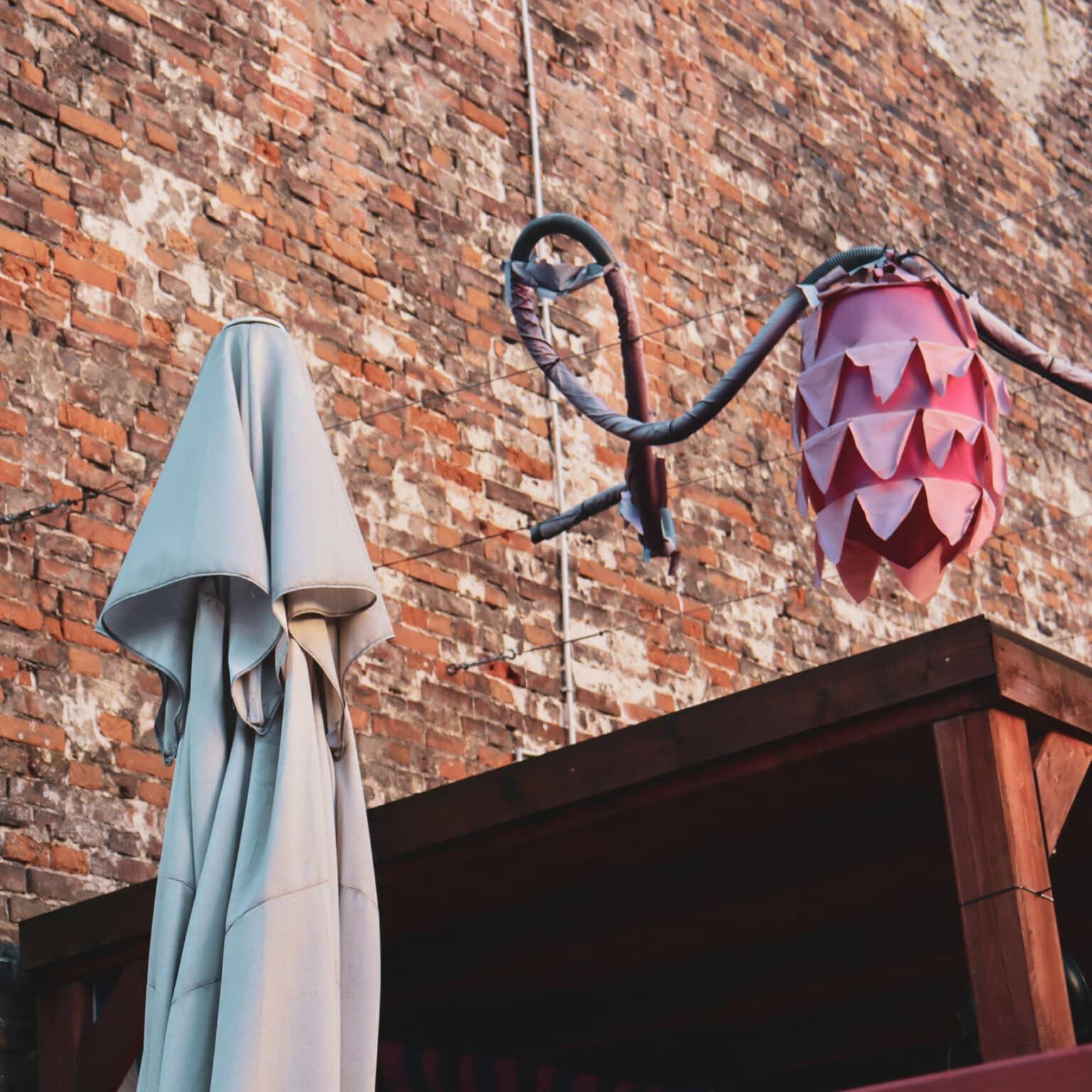 A garland hangs on a wire over a wooden roof.