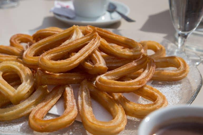 A plate full of fresh churros.