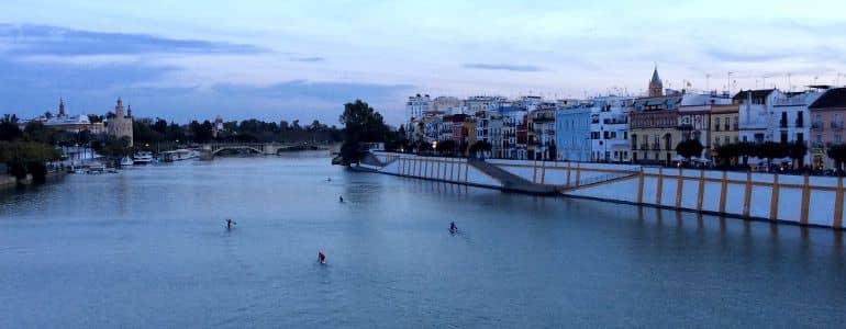 A beautiful view of the Guadalquivir with houses along the waterfront.