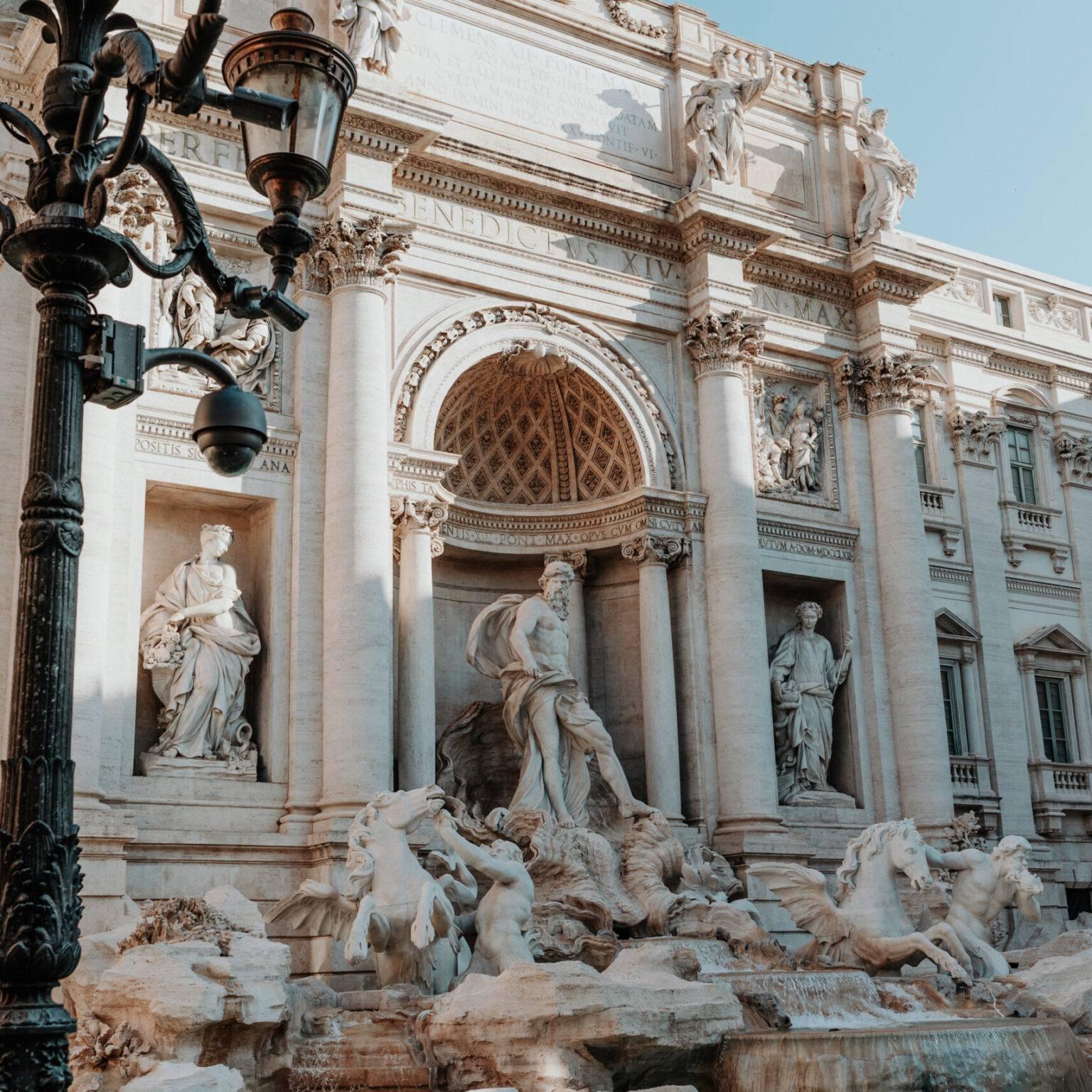 Trevi Fountain in Rome with intricate sculptures and water basin in daylight.