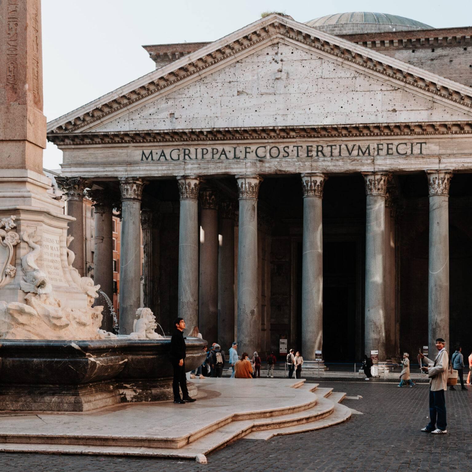 Pantheon in Rome with fountain and obelisk in the square, surrounded by visitors.