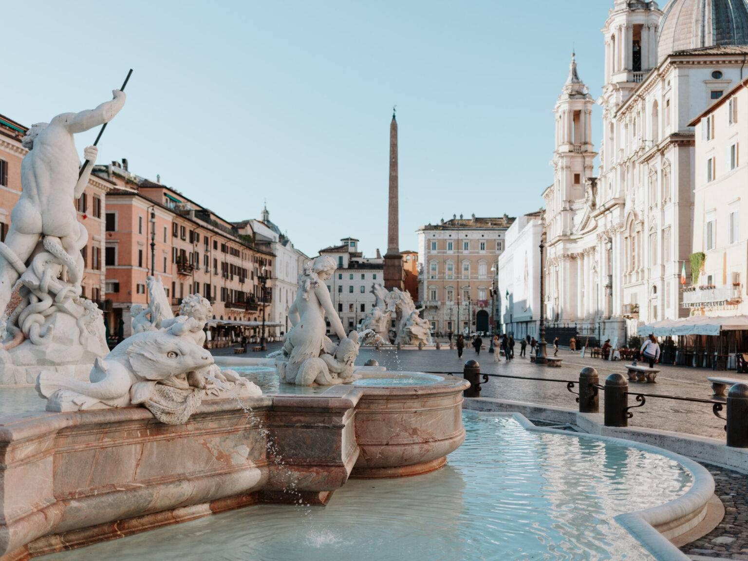 Piazza Navona in Rome with fountain, obelisk, baroque church, and lively square life.