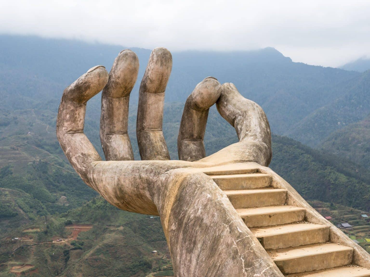 A giant stone hand with an embedded staircase on the grounds of the Moana cafe-restaurant.