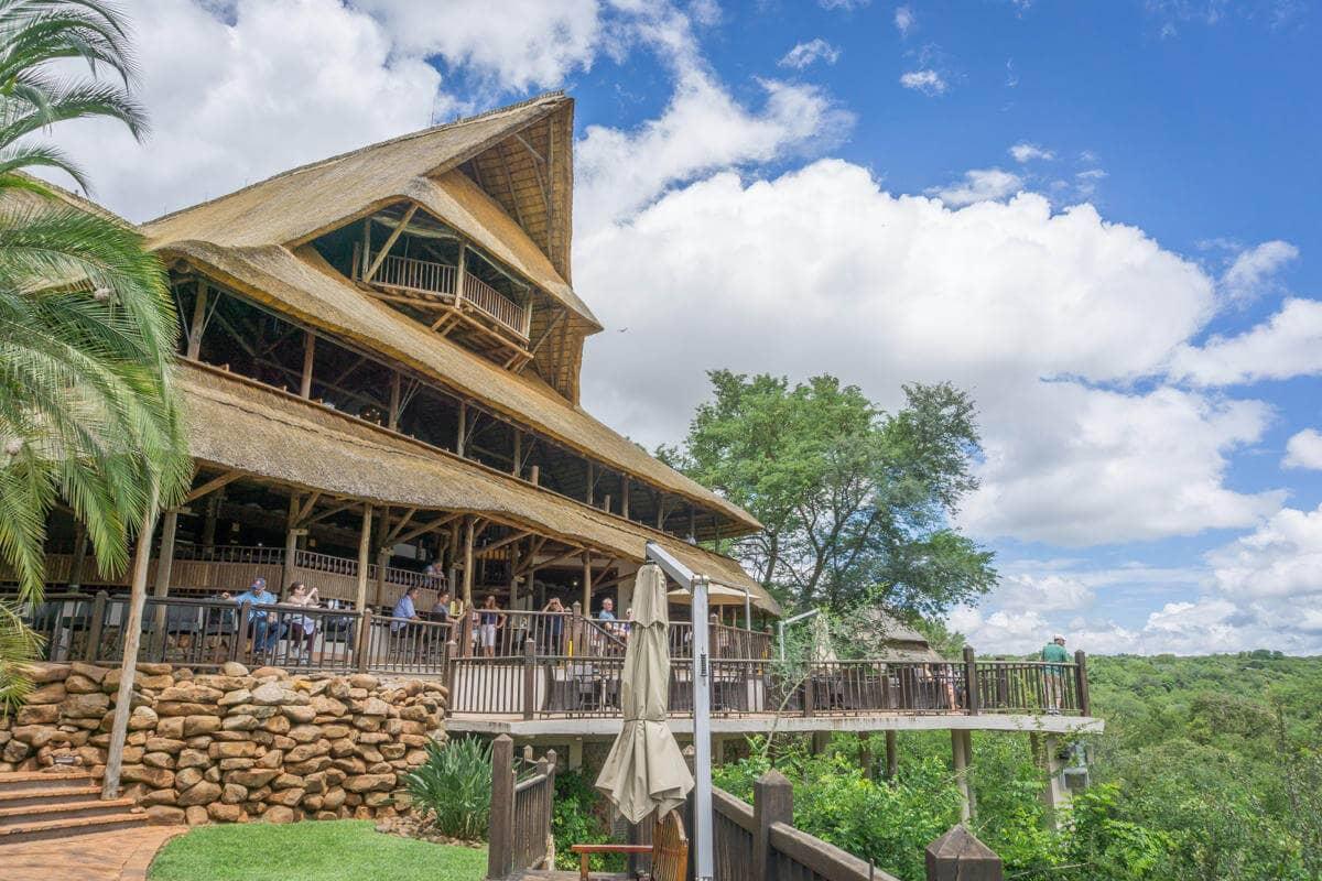 En medio de la naturaleza verde, se encuentra la Victoria Falls Safari Lodge con su techo de paja puntiagudo y su enorme terraza de madera.