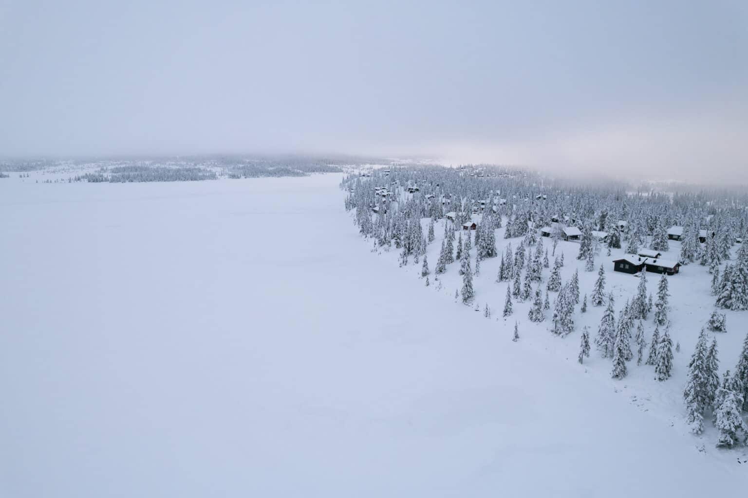 A frozen and snow-covered lake in the winter landscape in Sjusjøen