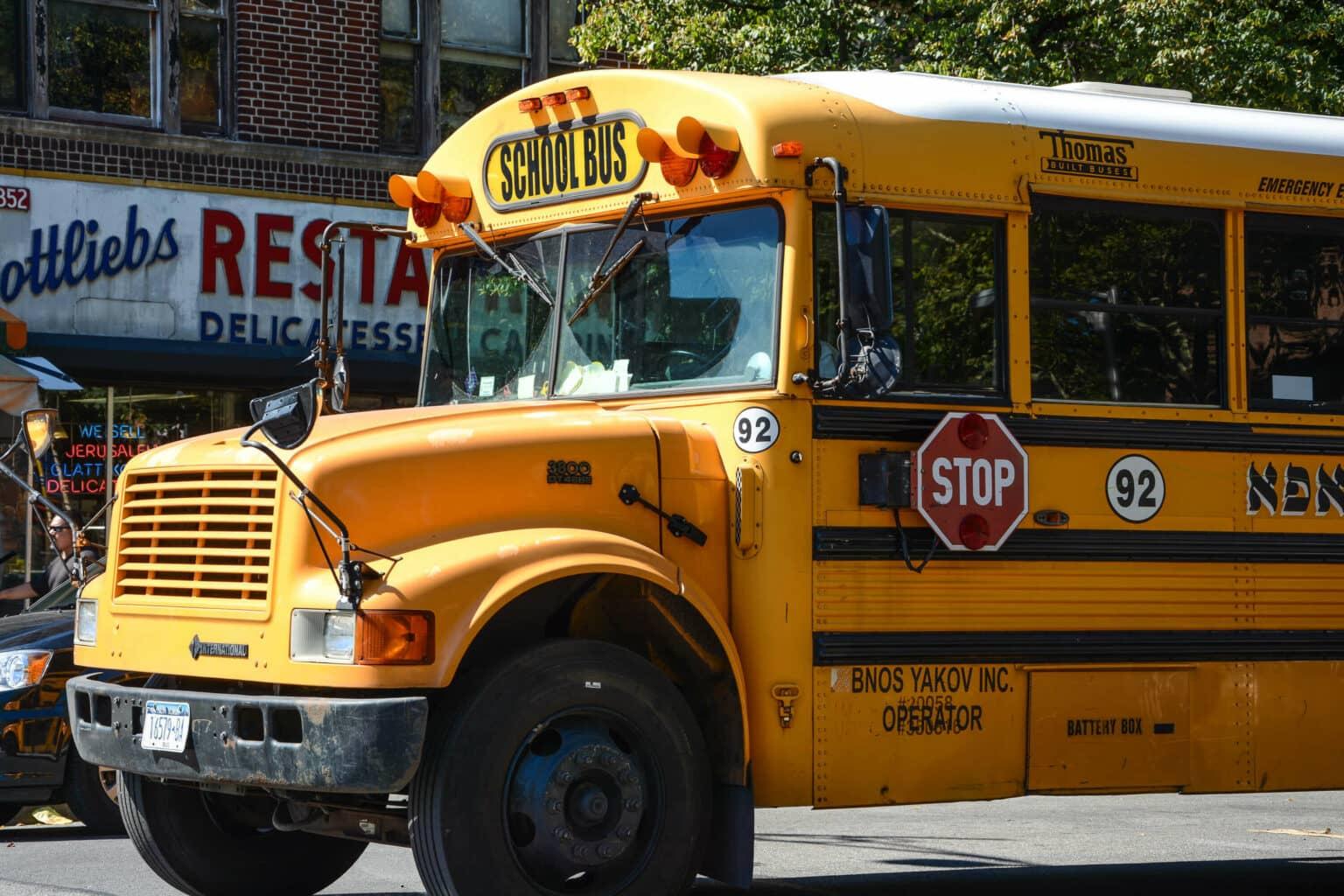 Yellow school bus on the streets of Williamsburg in Brooklyn, New York.