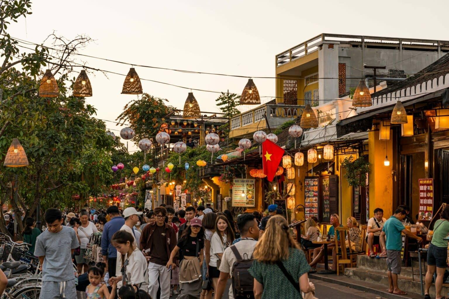 A bustling street in Hoi An's Old Town in the evening.