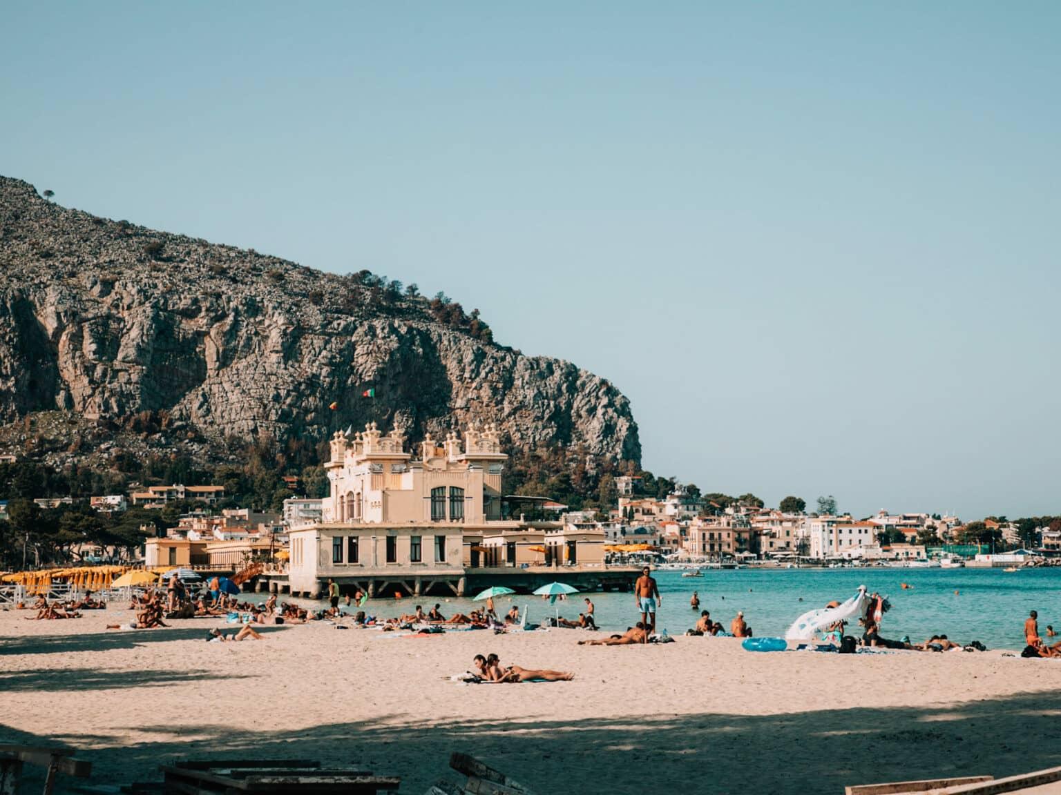View of the beach at Mondello with turquoise water in the background.