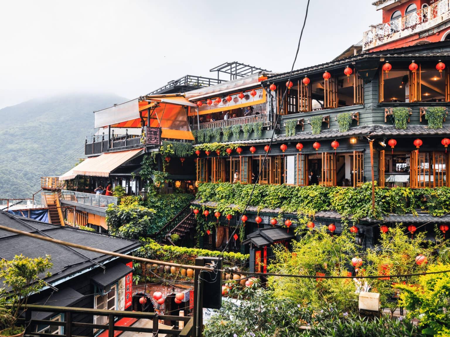 Houses in the mountain village of Jiufen in Taiwan adorned with orange lanterns.