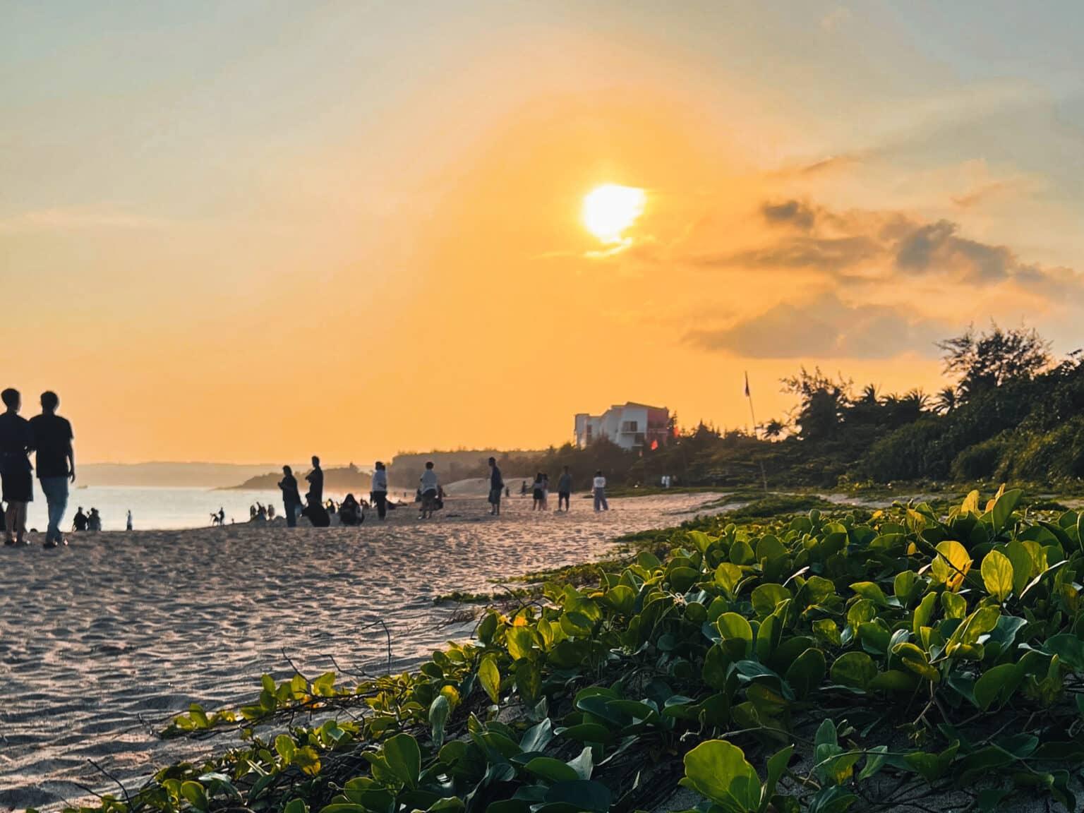 People watching the sunset on the beach at Dawan Beach in Taiwan.