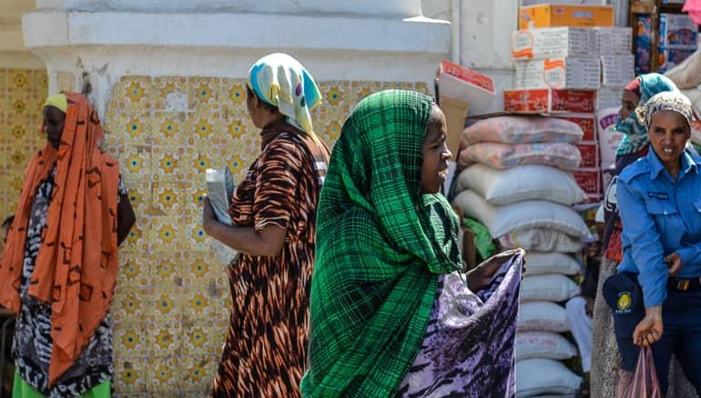 In the old town of Harar, Ethiopia, local women wear colorful dresses.