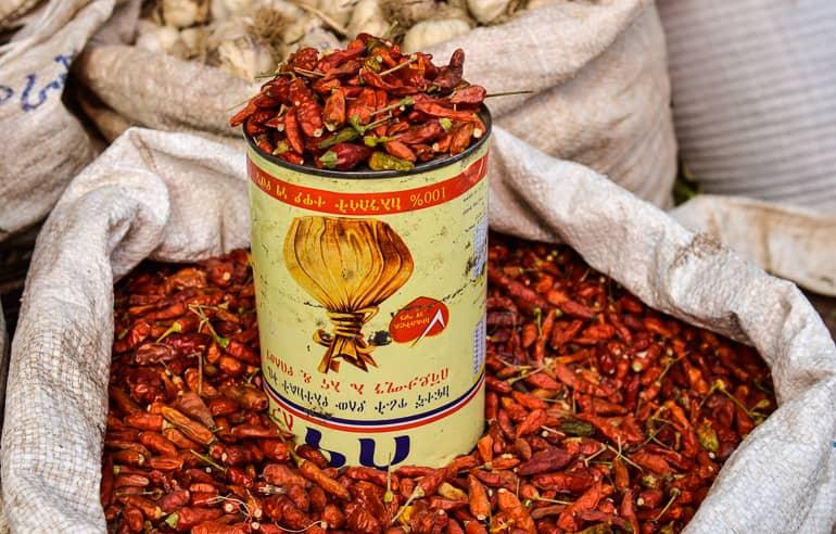 In a large white sack, small dried chili peppers are offered for sale at a market in Harar, Ethiopia.