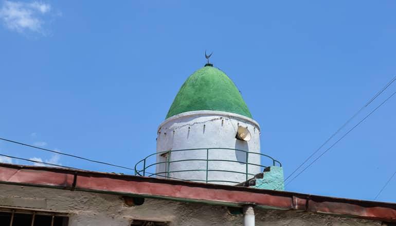 View of a minaret and its green spire in Harar, Ethiopia.