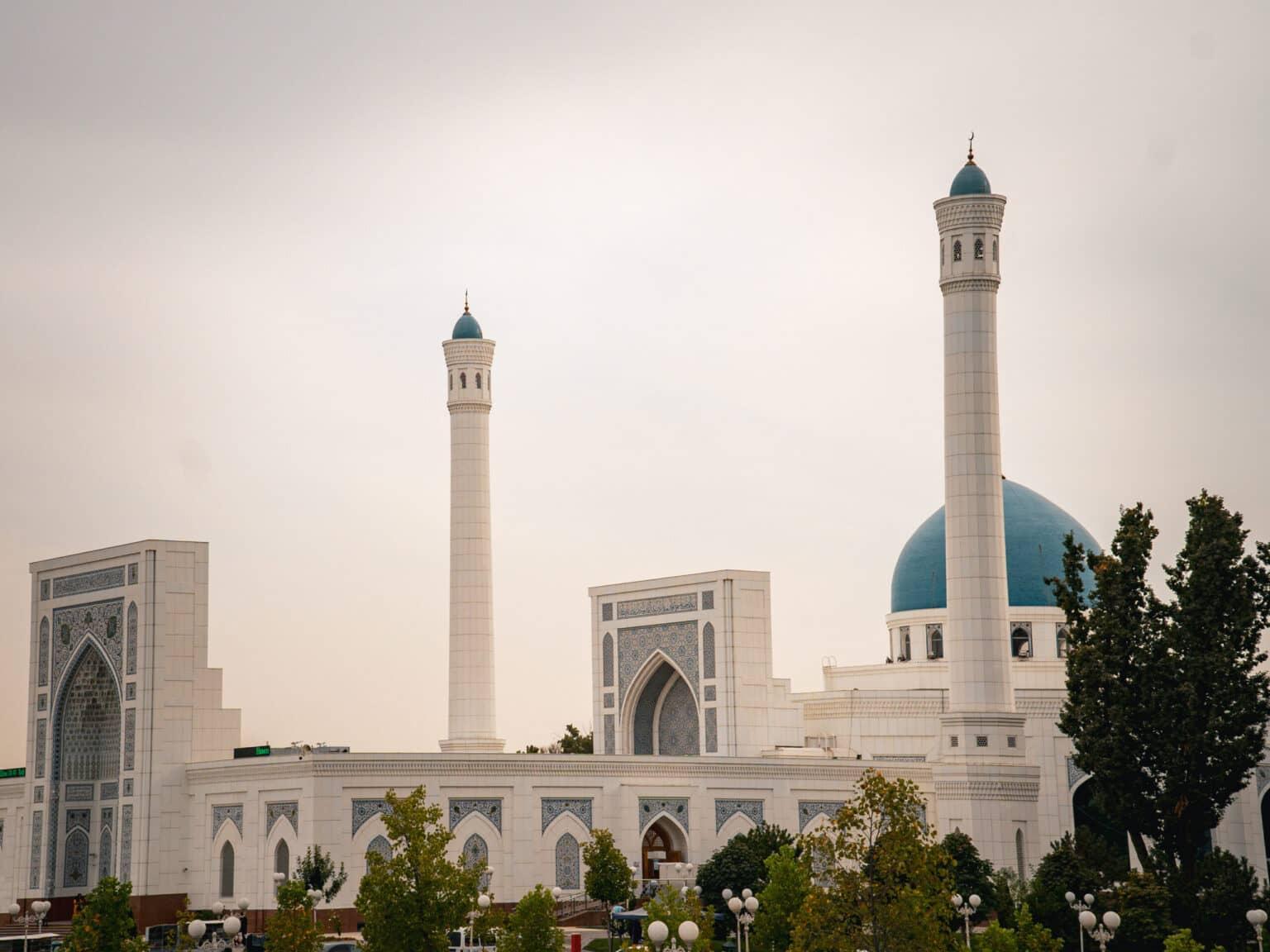 Exterior view of the Minor Mosque in Tashkent with two minarets and a turquoise dome