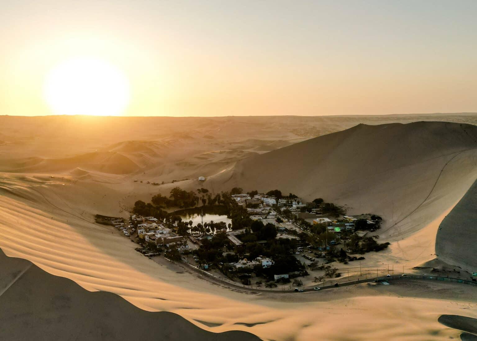 A small, lonely town surrounded by desert sand in the Huacachina desert in Peru.