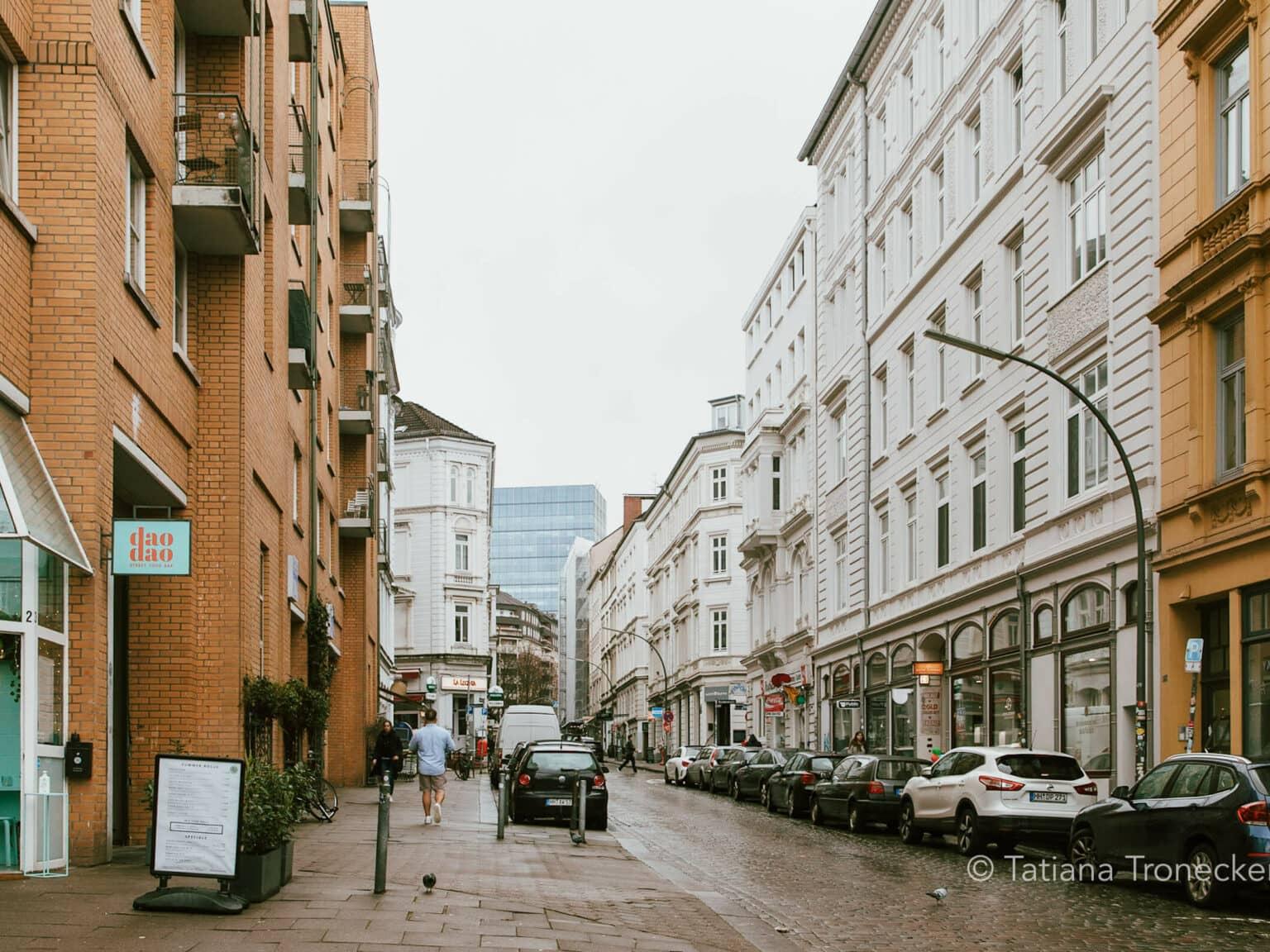Wexstraße in Hamburg with white and brick-colored houses.