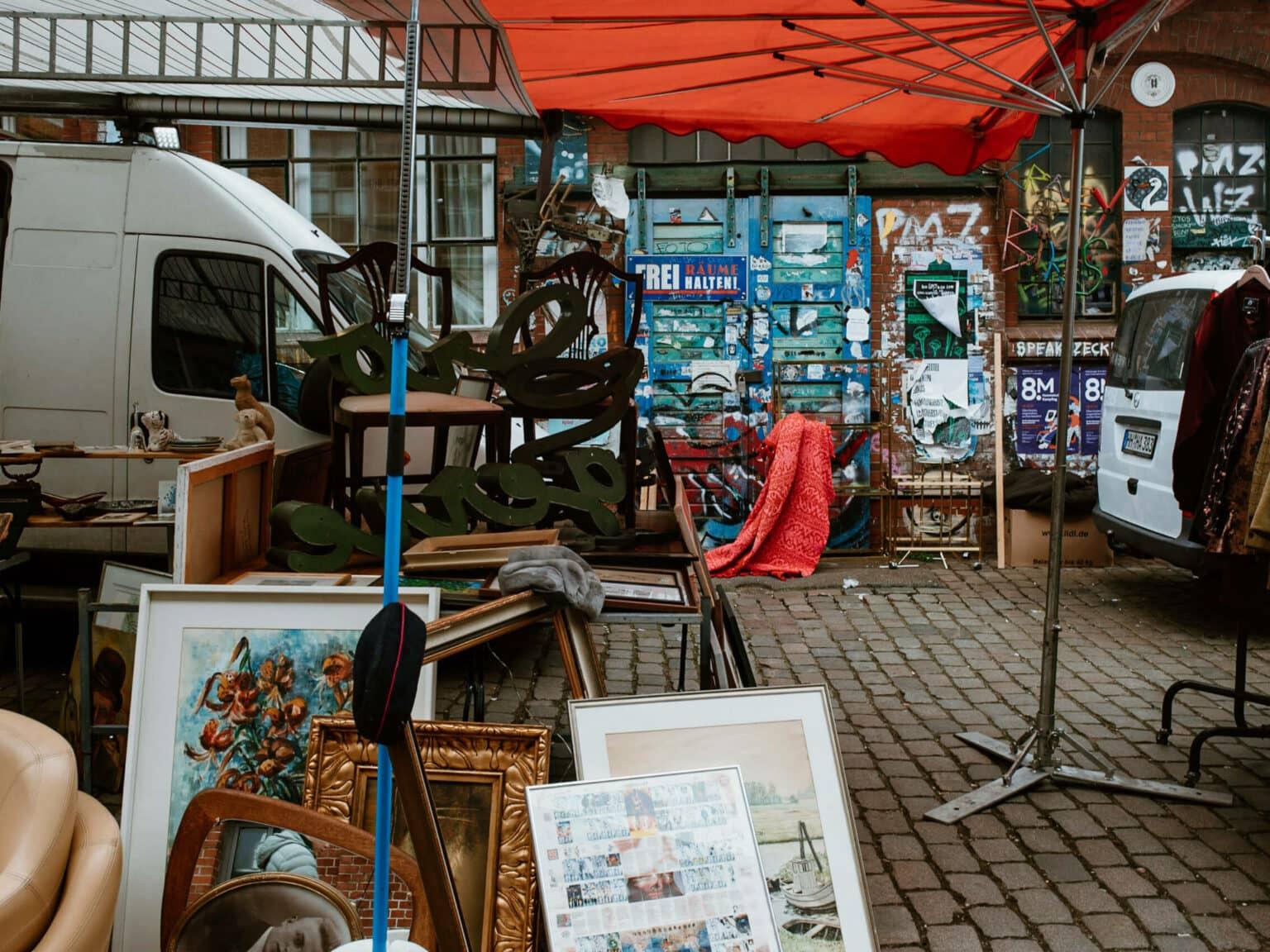 A flea market stand at Flohschanze in Hamburg with many antique items.
