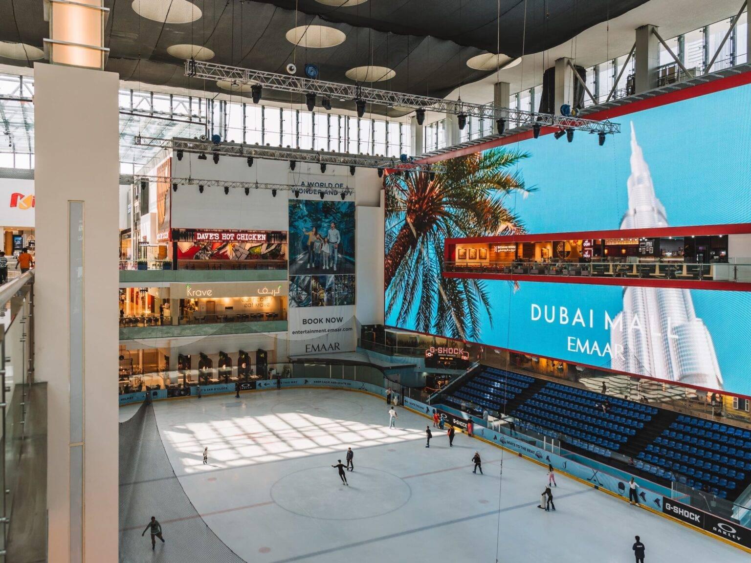 Some people ice skating on the ice rink in the Dubai Mall.