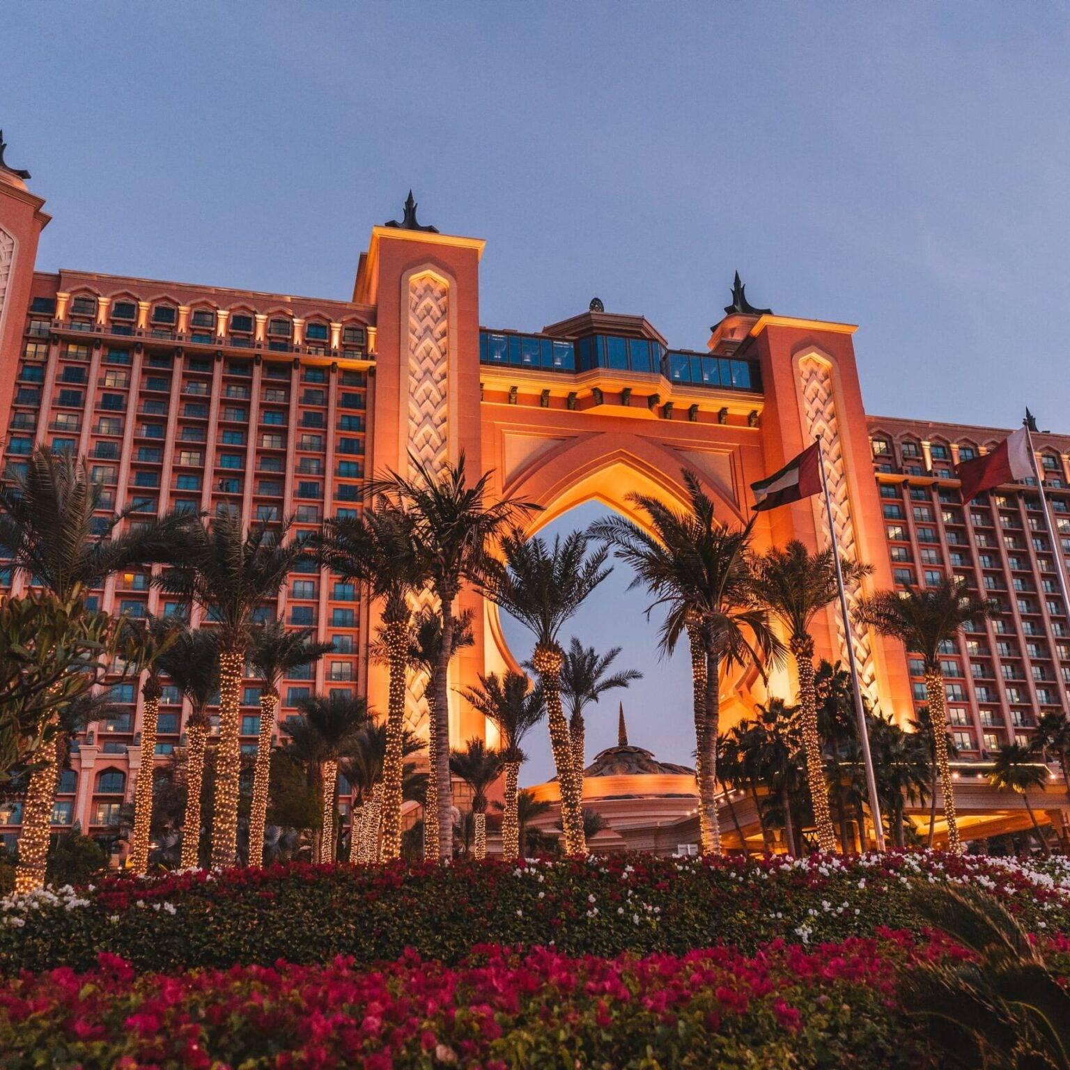 The facade of the Atlantis The Palm Hotel with palm trees in the foreground.