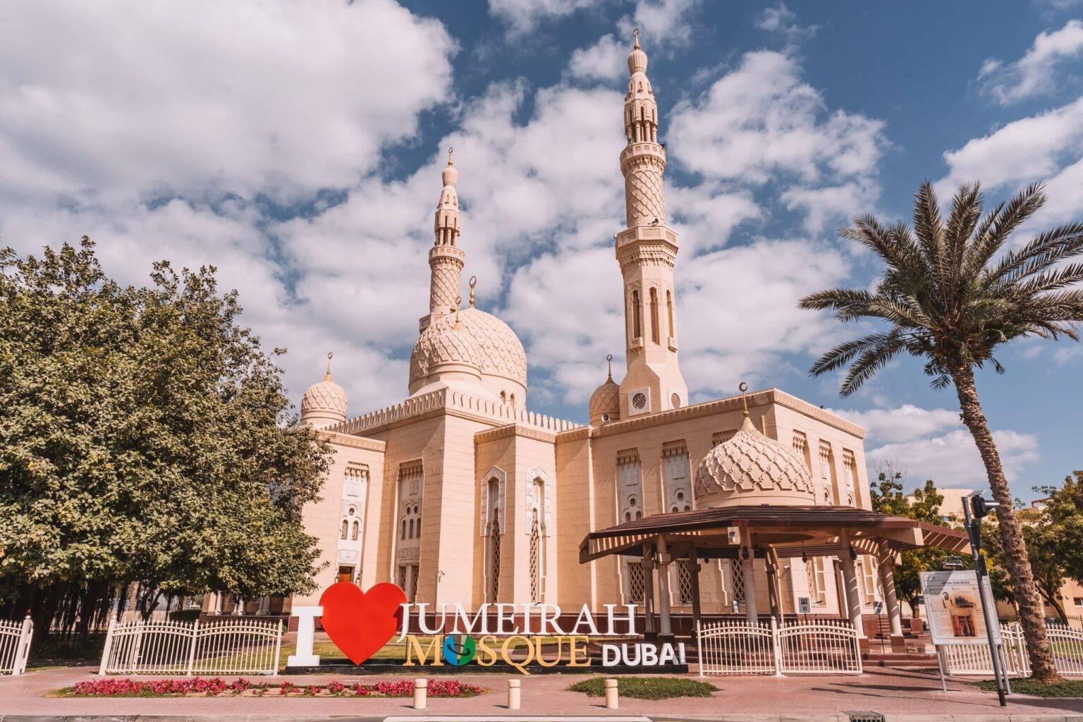 The facade of the Jumeirah Mosque. In front, a large sign reads "I love JUMEIRAH MOSQUE DUBAI".