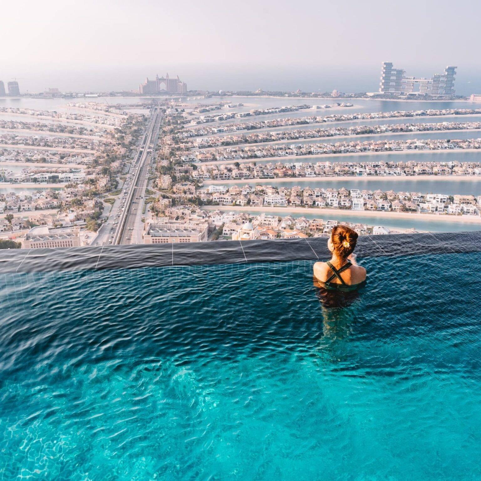 A woman in the AURA Infinity Skypool above Palm Jumeirah.