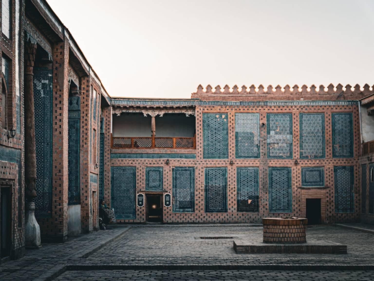 Inner courtyard of the Tosh-Haul Palace in Khiva with decorative mosaic walls and traditional architecture