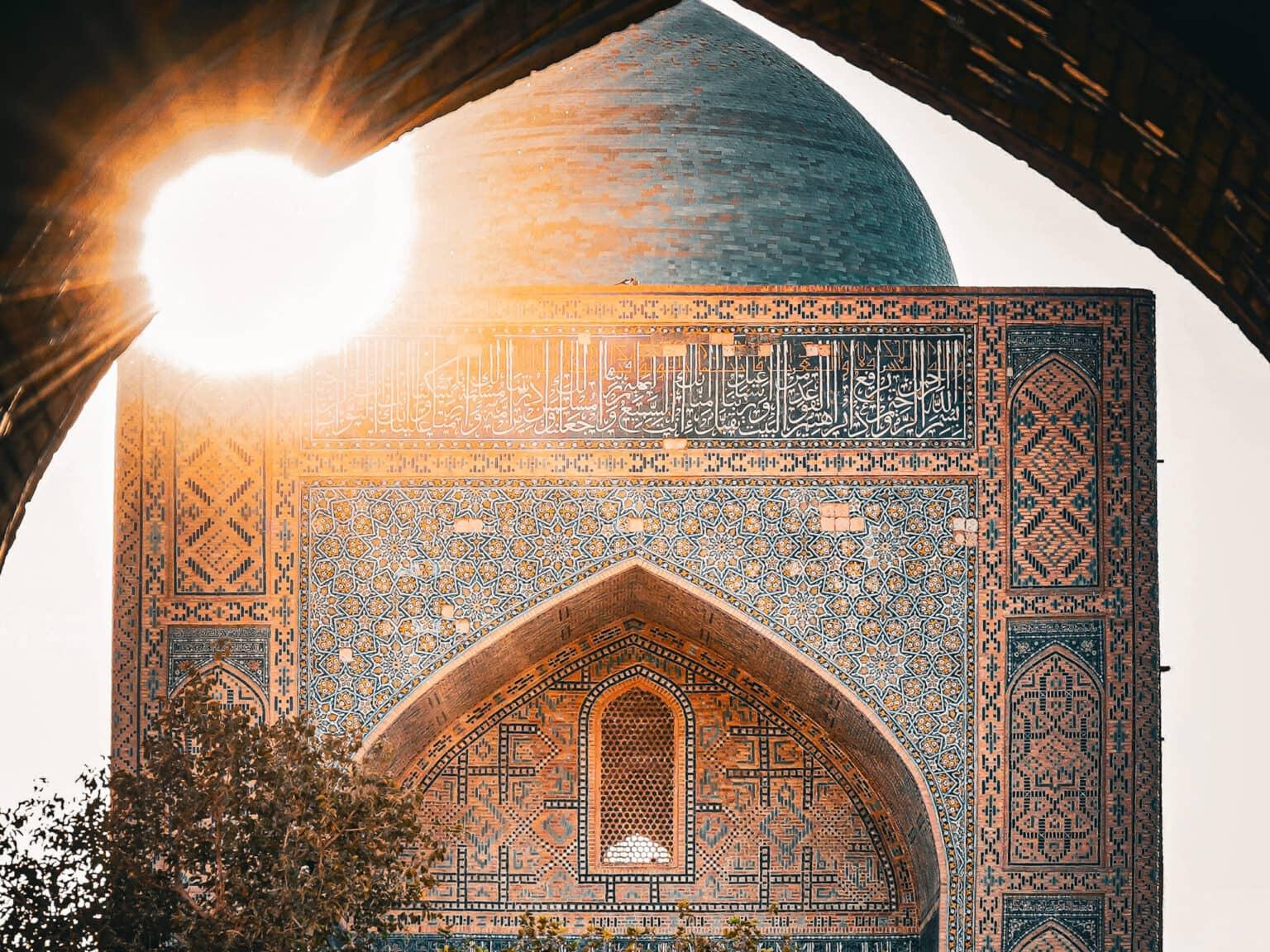 The facade of the Kalon Mosque in Bukhara glowing in the golden light of sunset