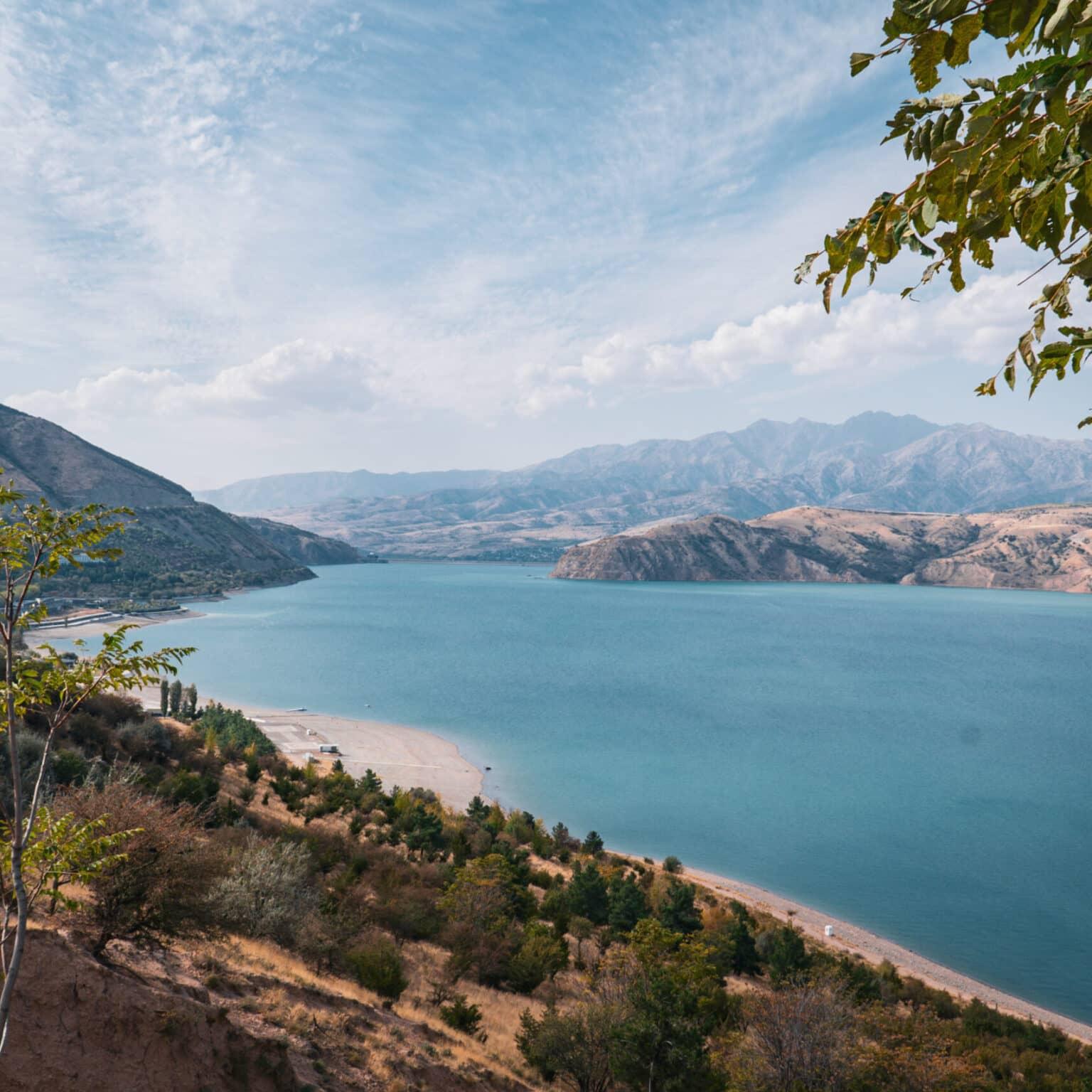 View of the blue Charvak Lake in the Chimgan Mountains of Uzbekistan from a hilltop